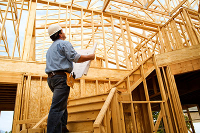 a man standing on top of a wooden frame