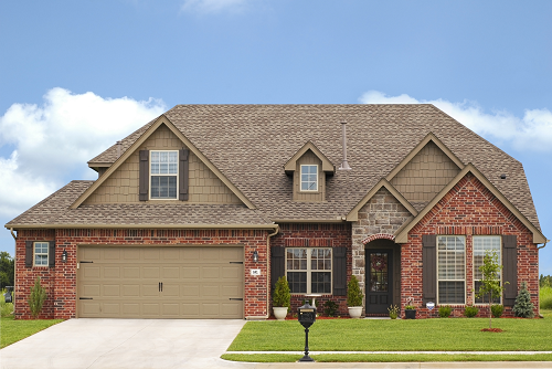 a large brick house with grass in front of a house